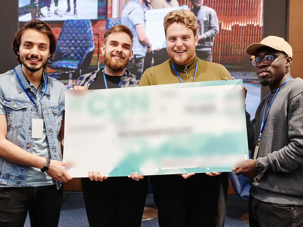 Students celebrating on stage at a university technology event